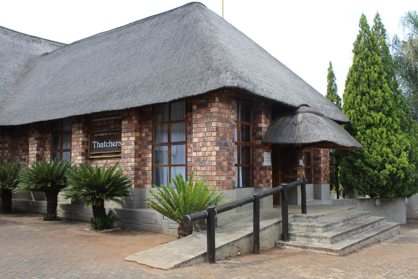 The Thatchers: a thatched brick building with its name sign