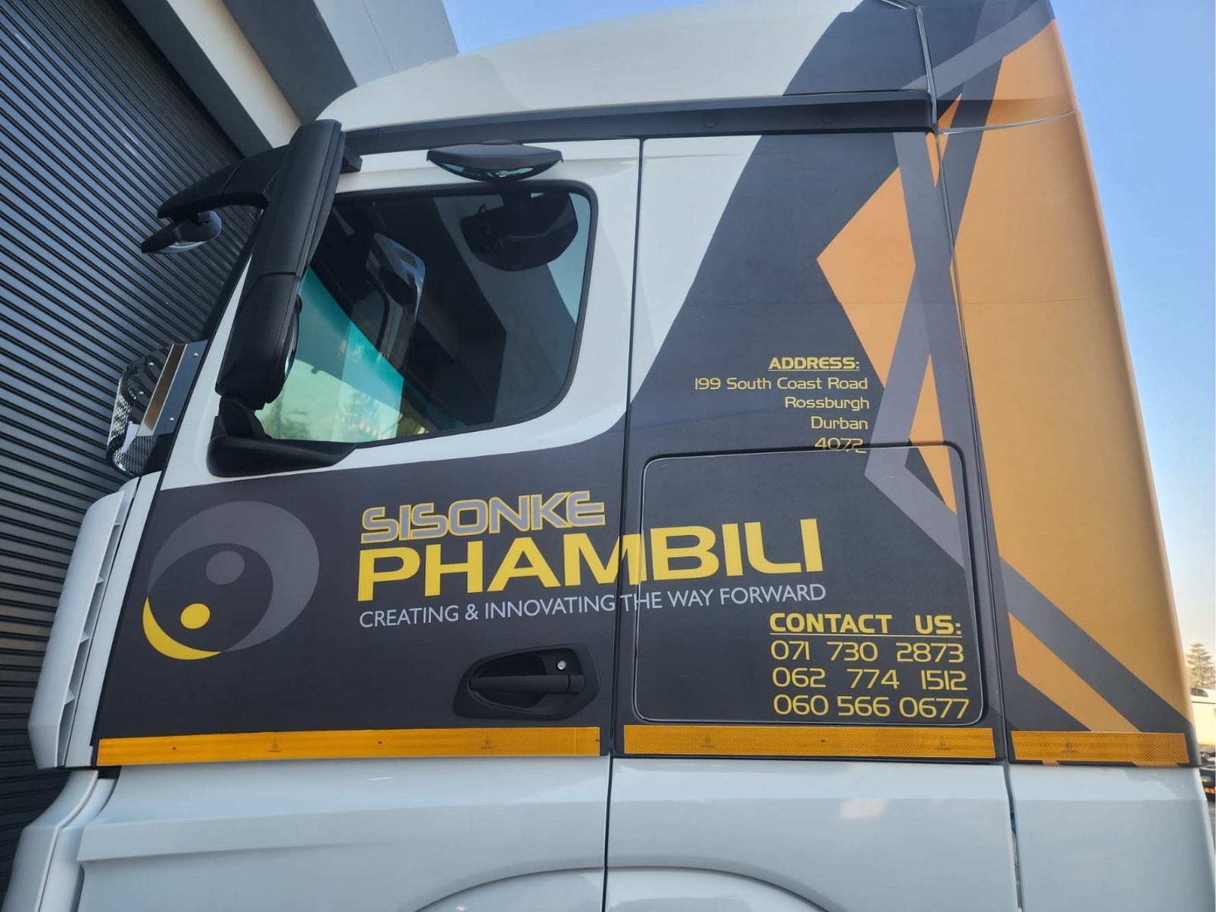 A truck cab branded by The Print Lab for Sisonke Phambili: logo, address and contact numbers on the door